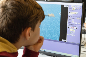 boy sitting in front of computer